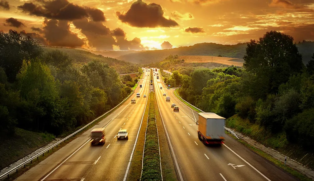 View of Trucks and Cars on Highway at Sunset | Guide to BlaBlaCar